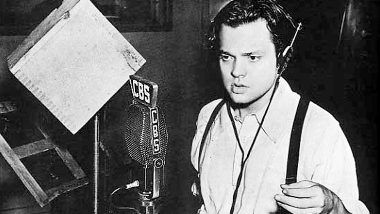 Orson Welles at radio microphone