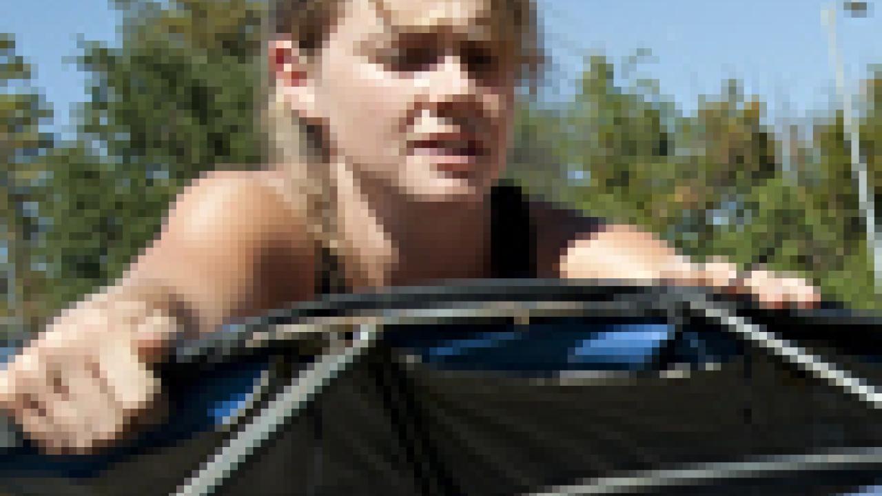 Photo: May Wilson installs her whale art.