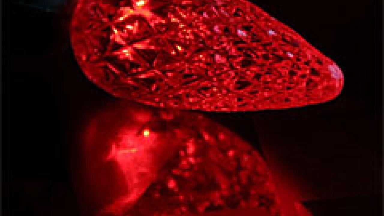 Photo: red Christmas light LED bulb and reflection