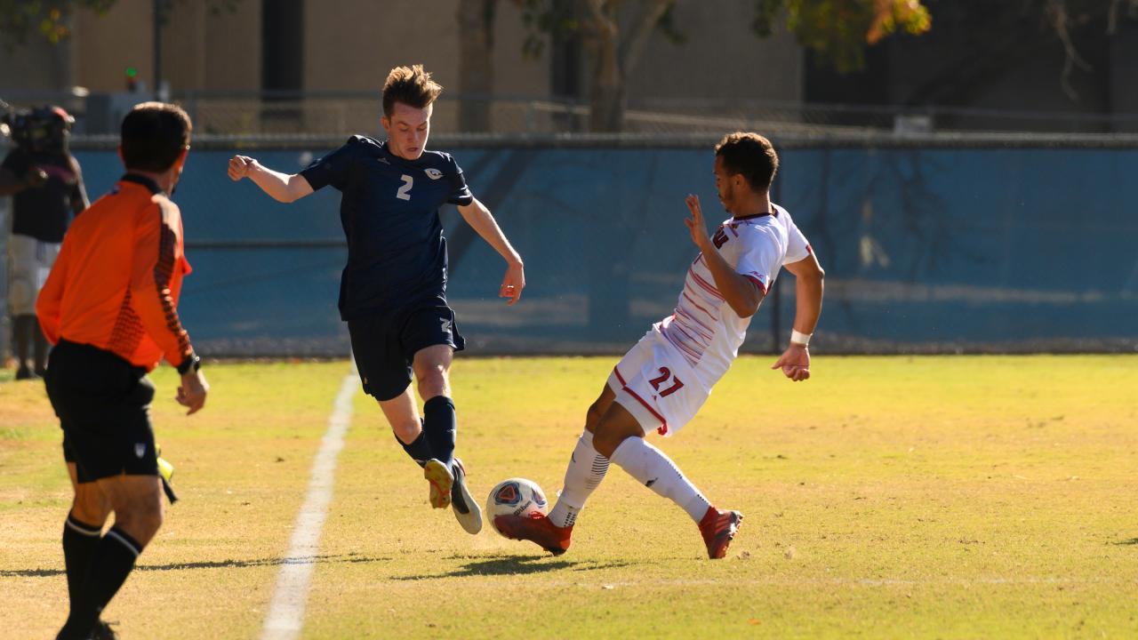Adam Mickelson (2) dribbles the ball downfield during the playoff soccer match between UC Davis and Louisville on November 24, 2019.