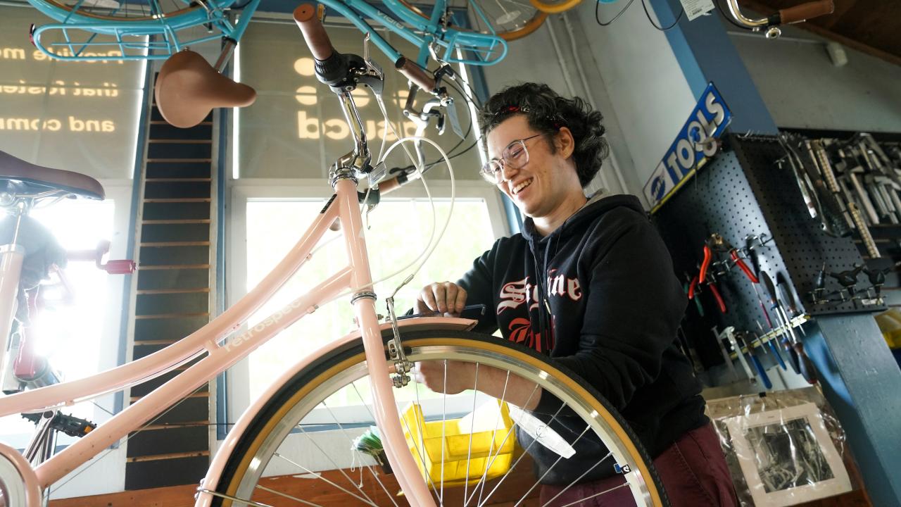 A student works on a bicycle at UC Davis. 
