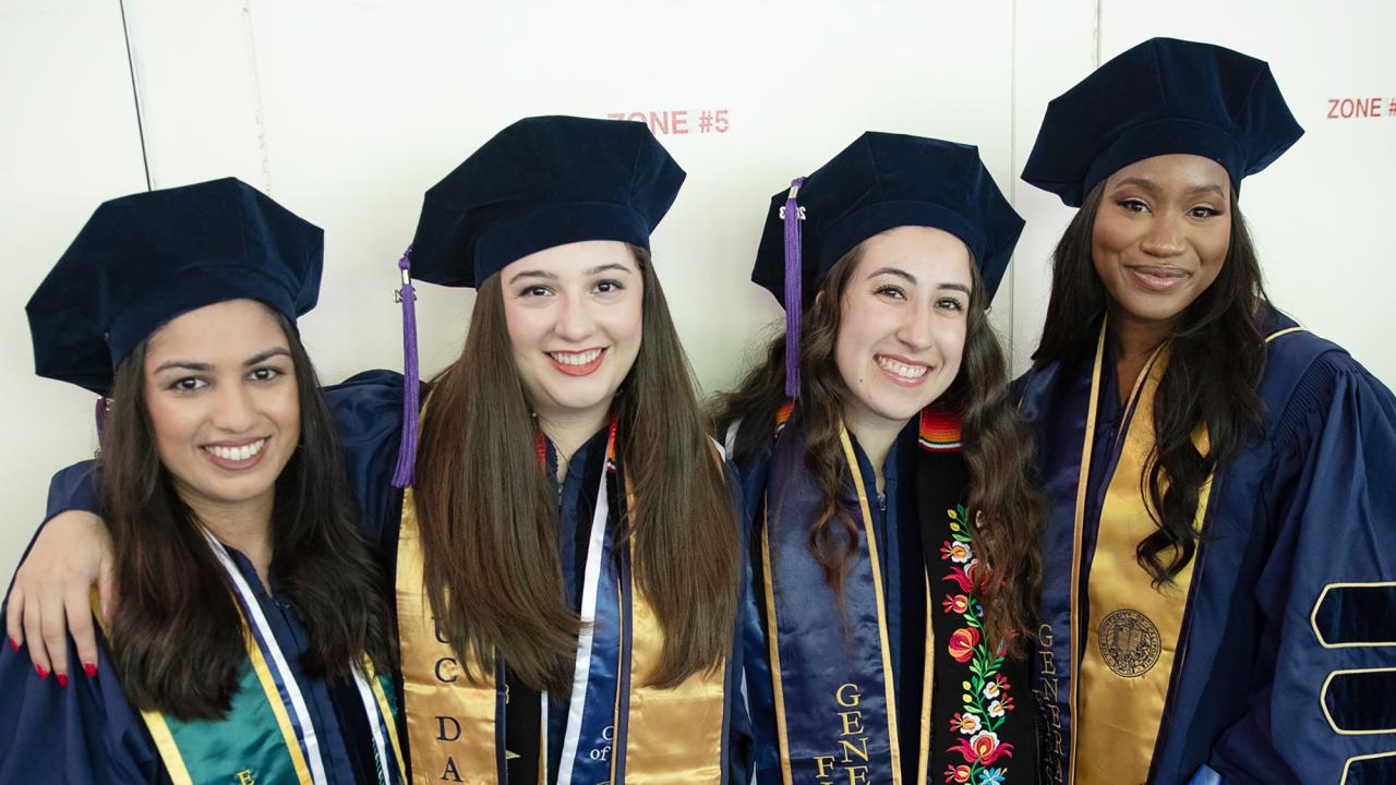 Four female graduates of the law school pose