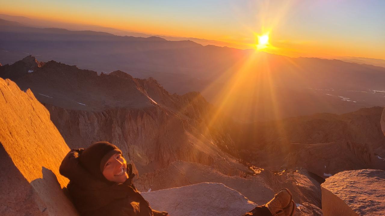 Grace Cureton poses with the Mount Whitney sunrise