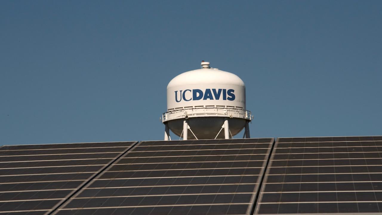 solar panels in foreground with /uC Davis water tower in background