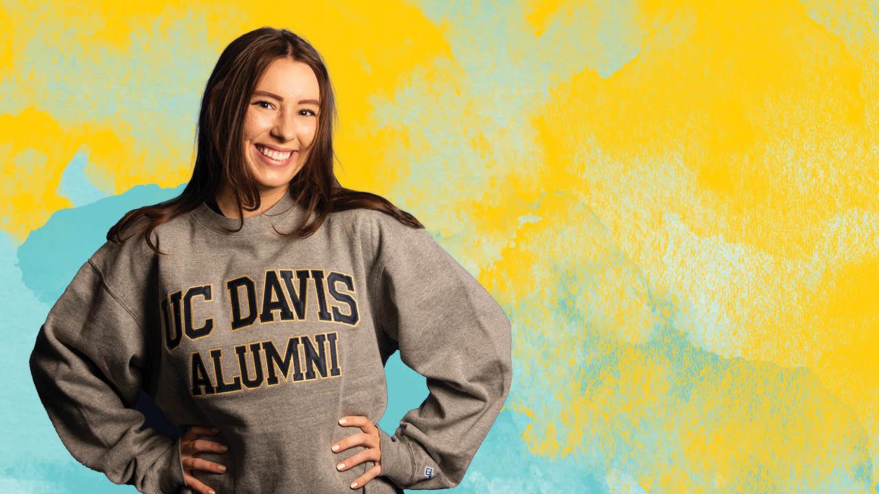 A student modeling a grey UC Davis Aggies sweatshirt