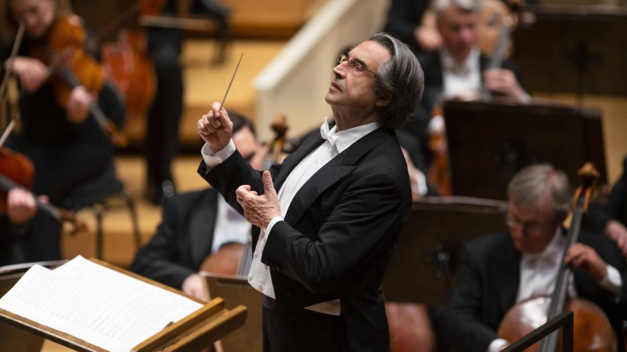 Man in tux directing symphony