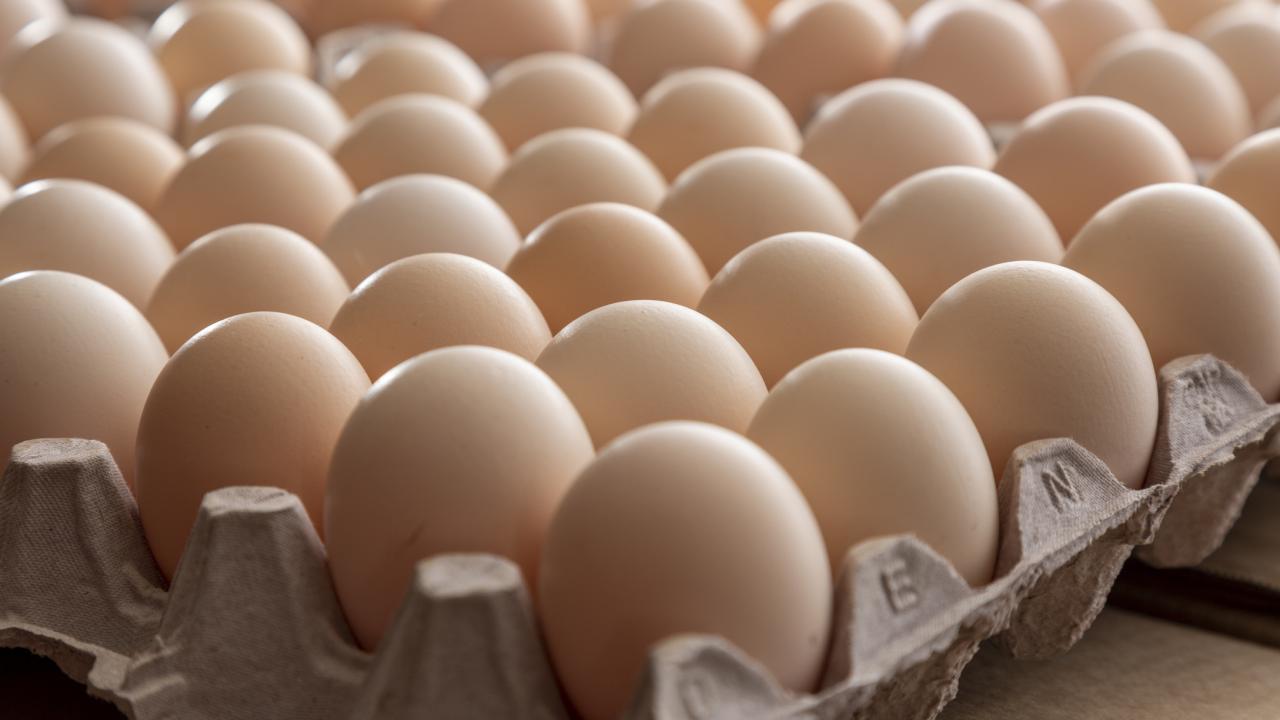 Light brown eggs in a carton, viewed from a corner of the carton. 