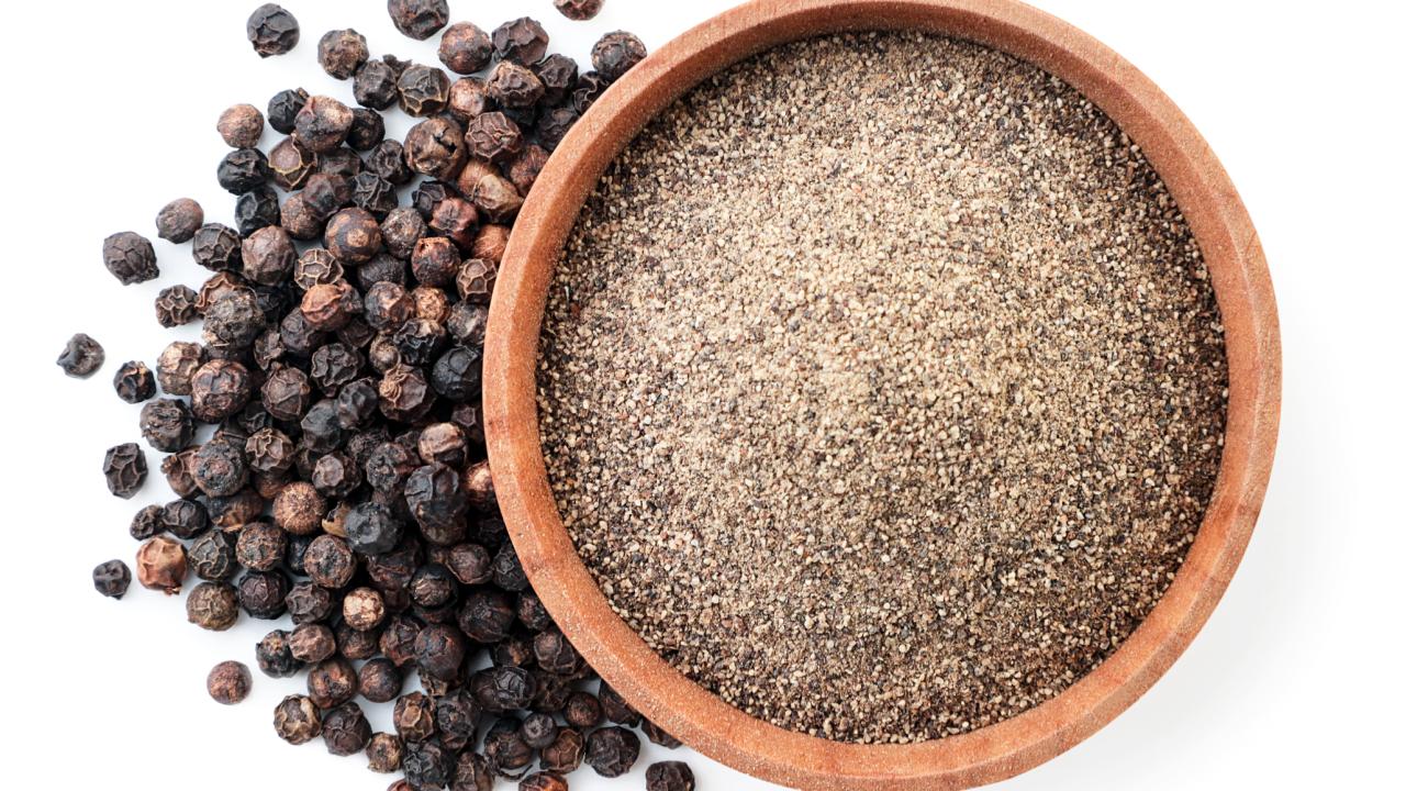 Photo of peppercorns and ground pepper