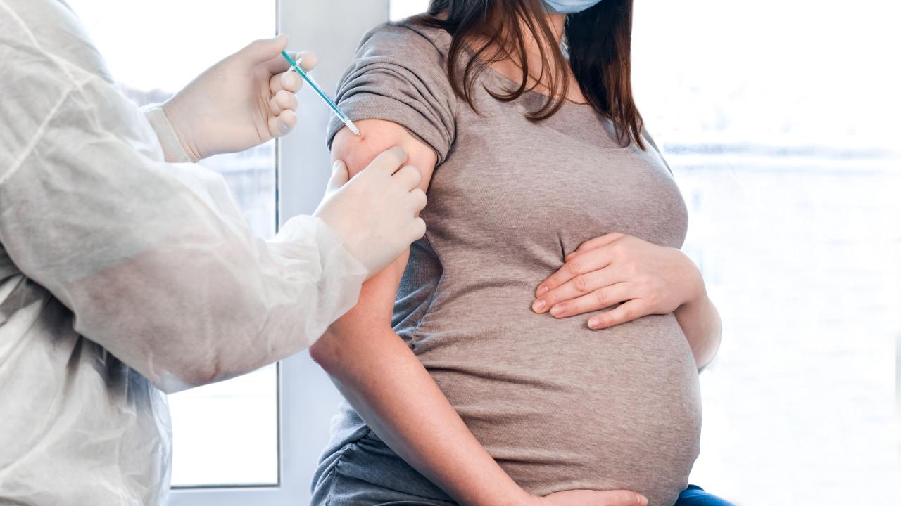 Pregnant woman receiving immunization