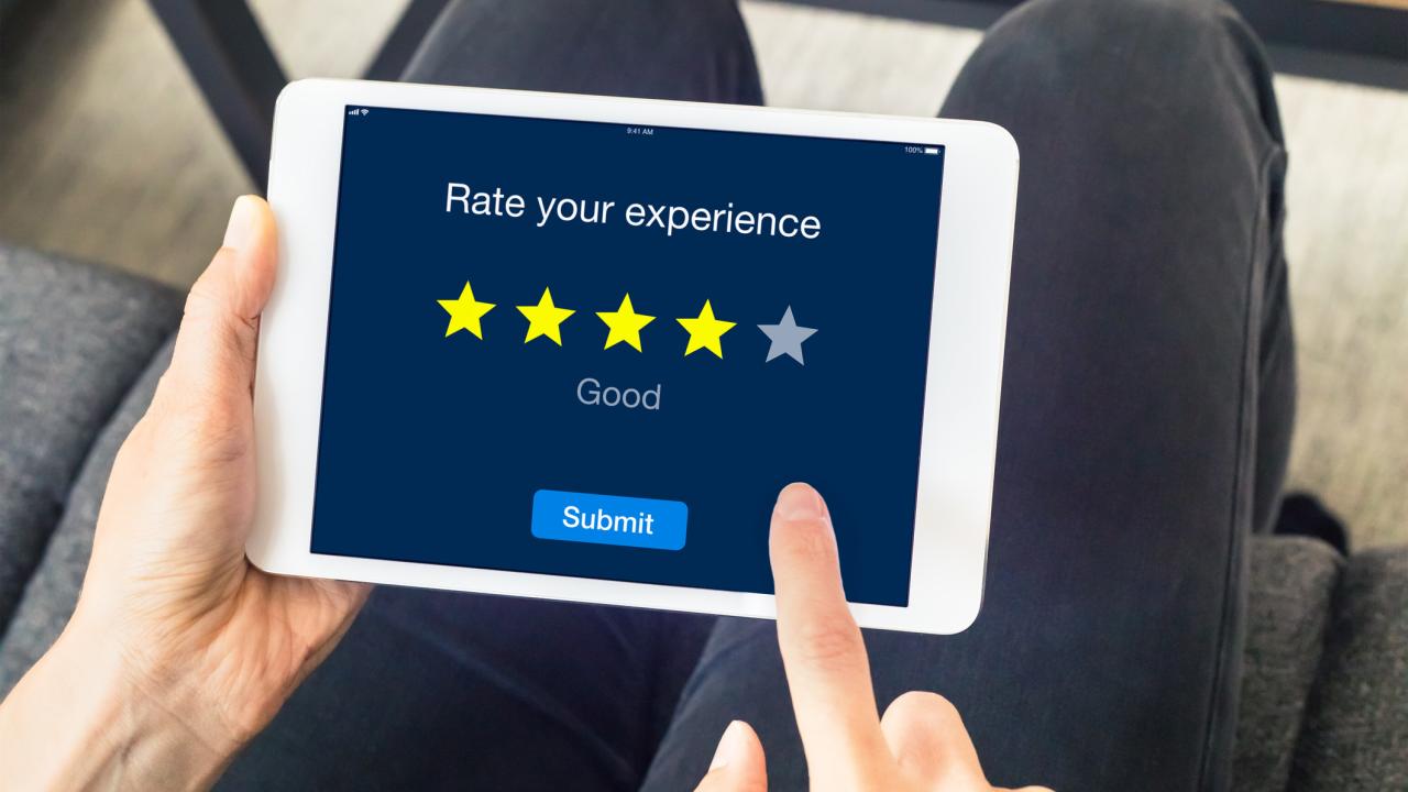 Finger pointing to stars on computer screen signifying a product or service rating 