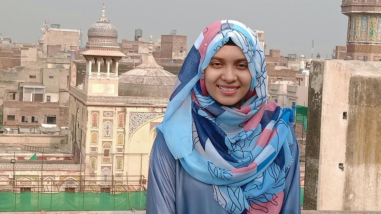Hijab Khan against skyline of Lahore, Pakistan