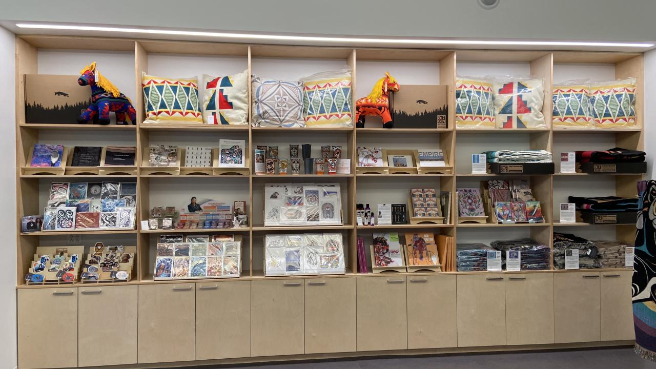 Rows of books, mugs, pillow in store display at UC Davis Gorman museum