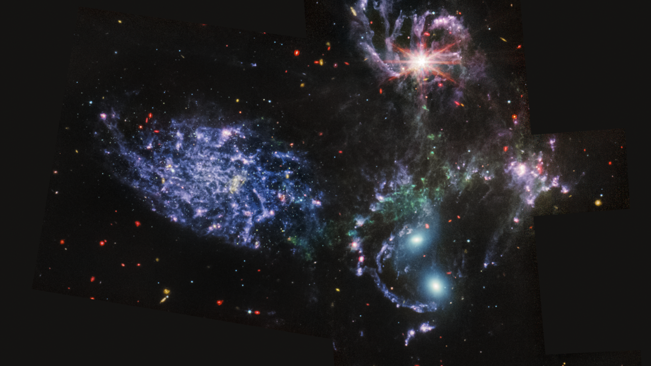 Five brightly colored galaxies against a black background