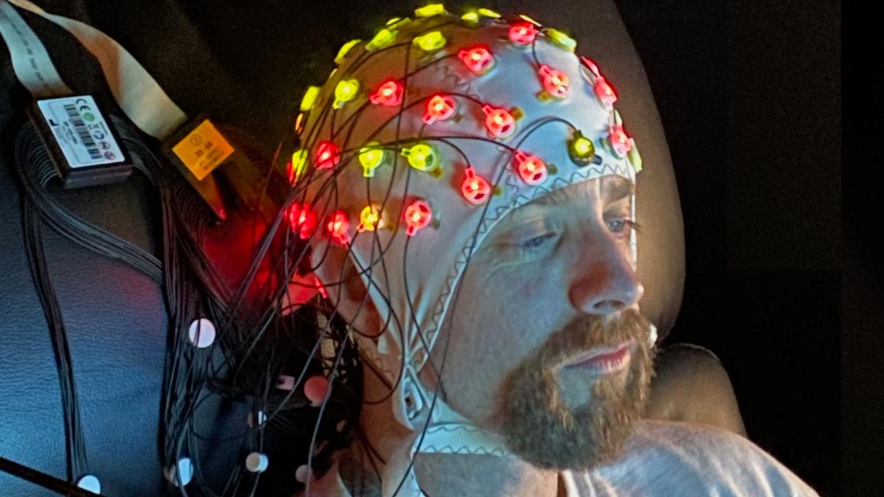 Individual with EEG equipment on head 