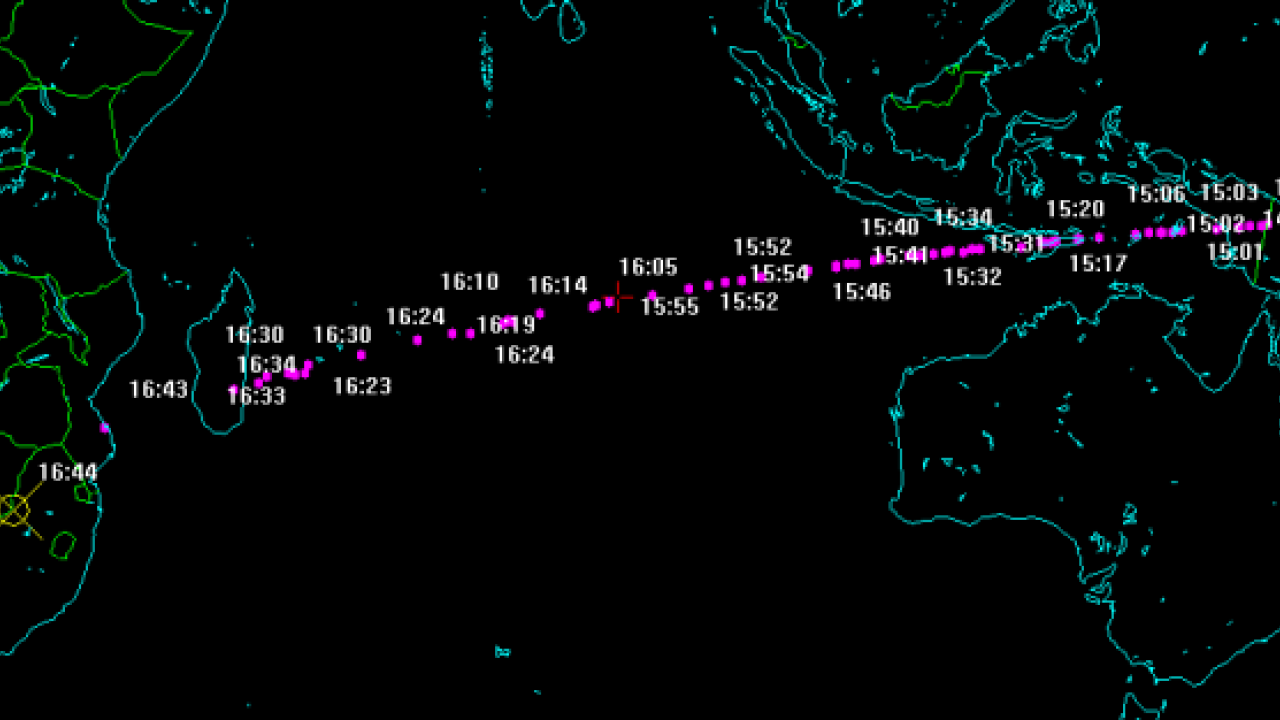 Map of the world outlined in green on a black background, with a purple meteor track across it
