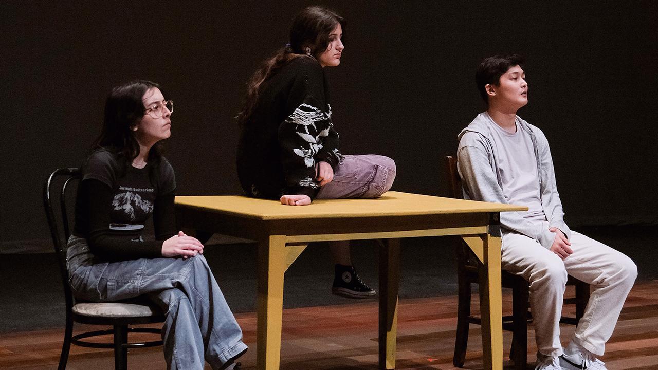 Students on a stage rehearsing play