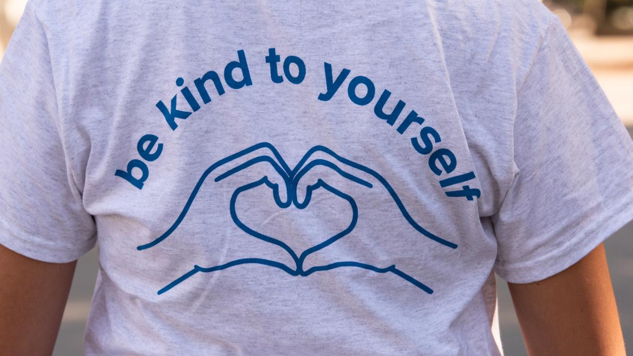 "Be Kind to Yourself" T-shirt, with hands making a heart