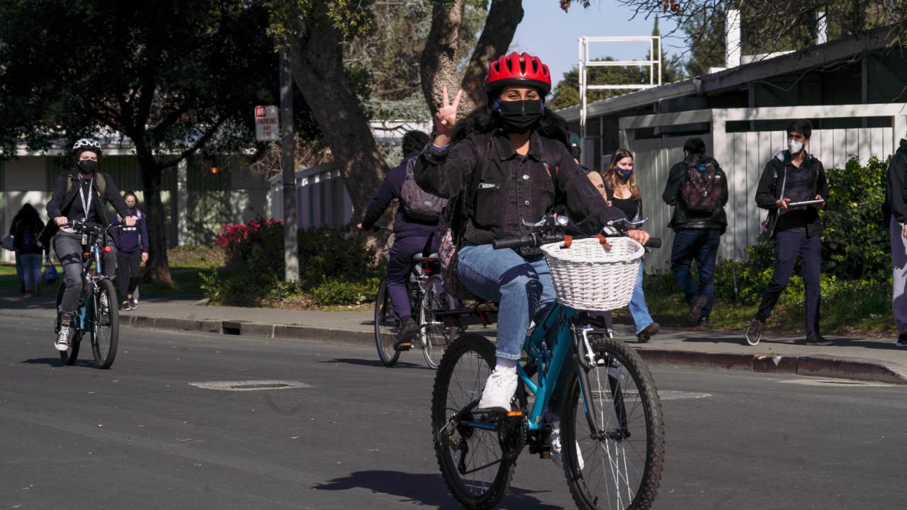 Bicyclist flashes peace sign