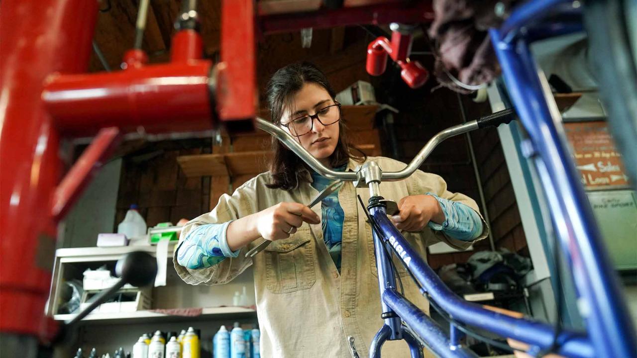 Student works on bicycle