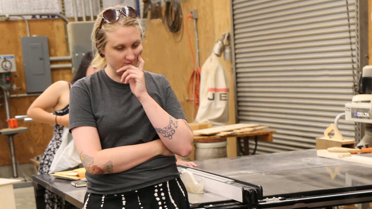 Woman casts a critical eye on a furniture design project.