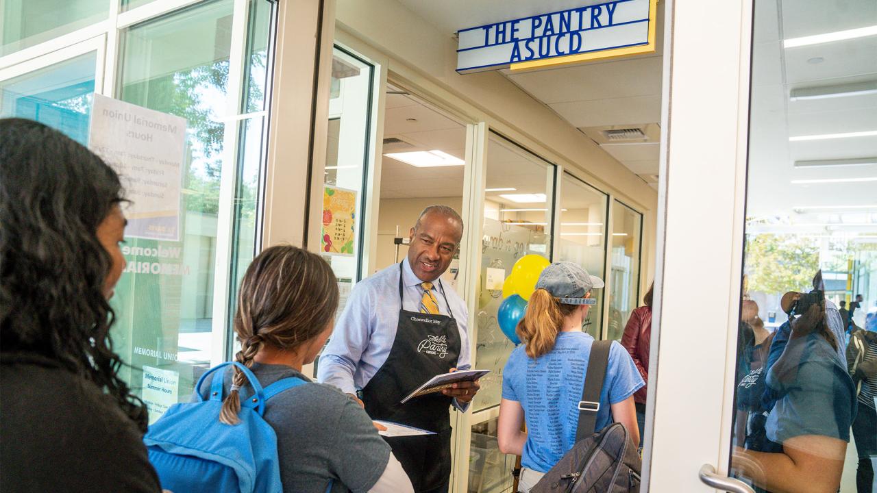 Chancellor Gary S. May greets students walking into the Pantry