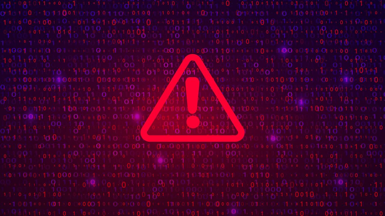 Alert symbol: Red triangle and exclamation point against background of computer code