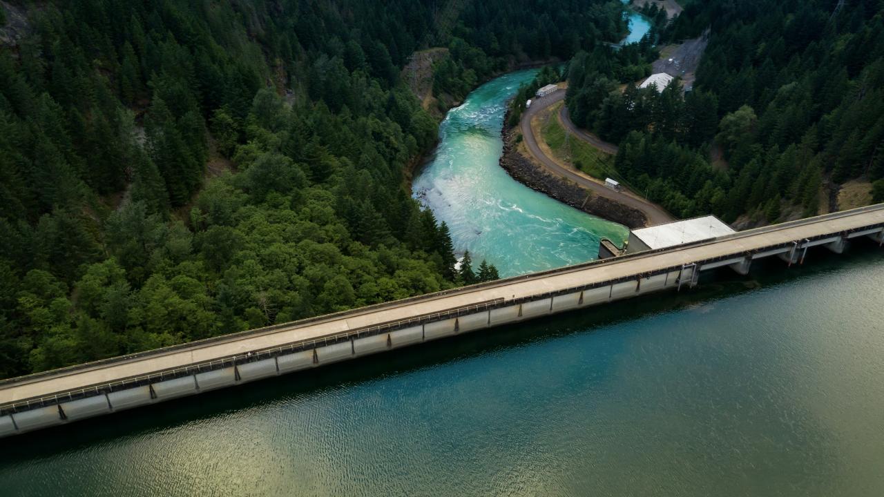 Reservoir holds back water above flowing river in Oregon