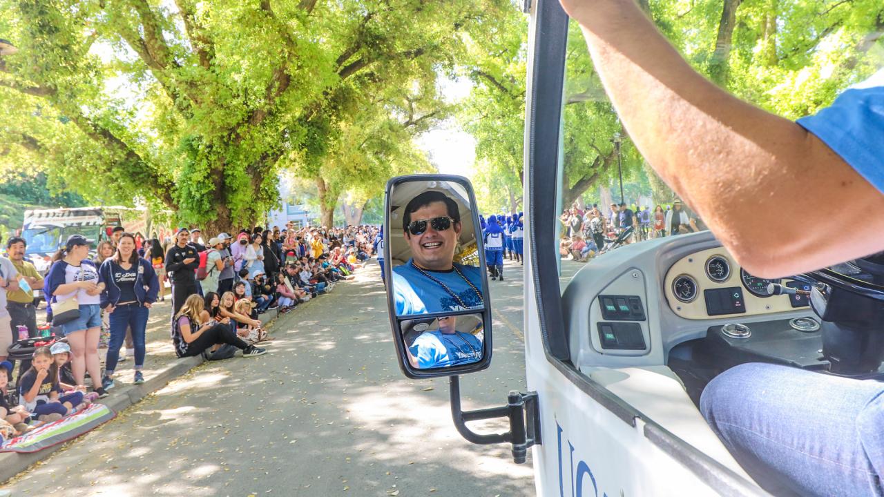 Tram driver as seen in rearview mirror, during parade