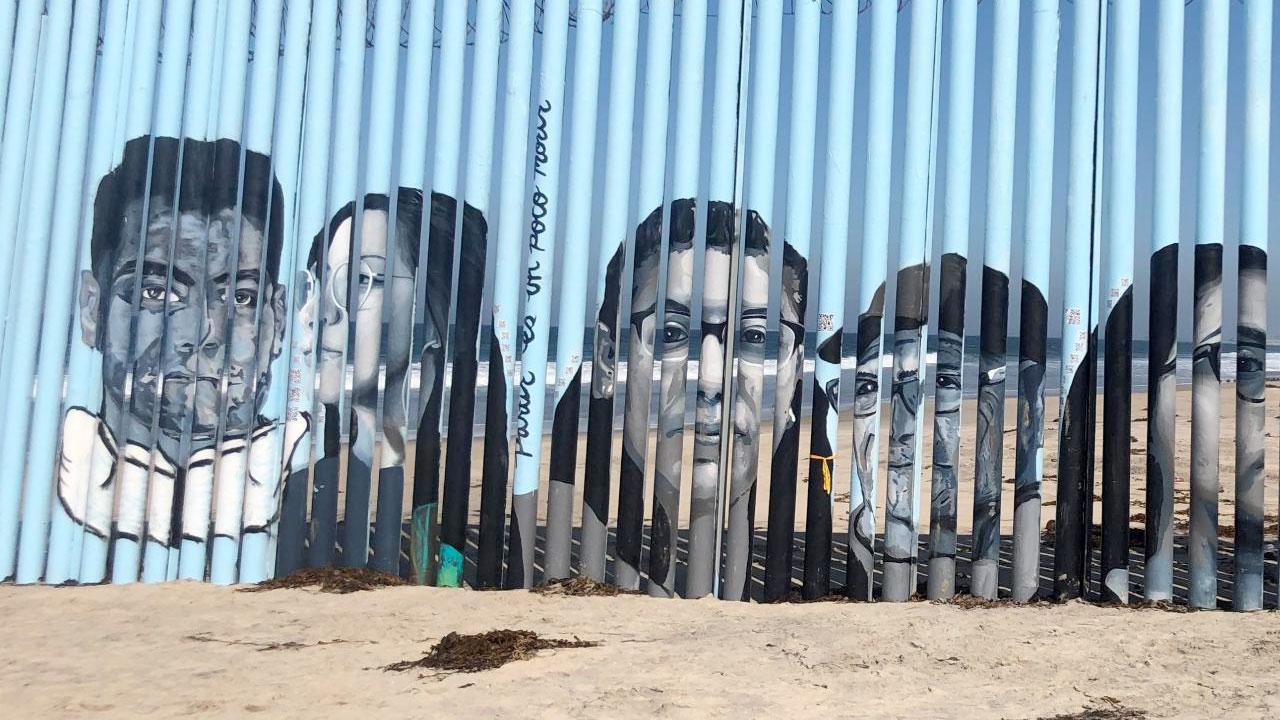 Painted portraits on the southern border wall
