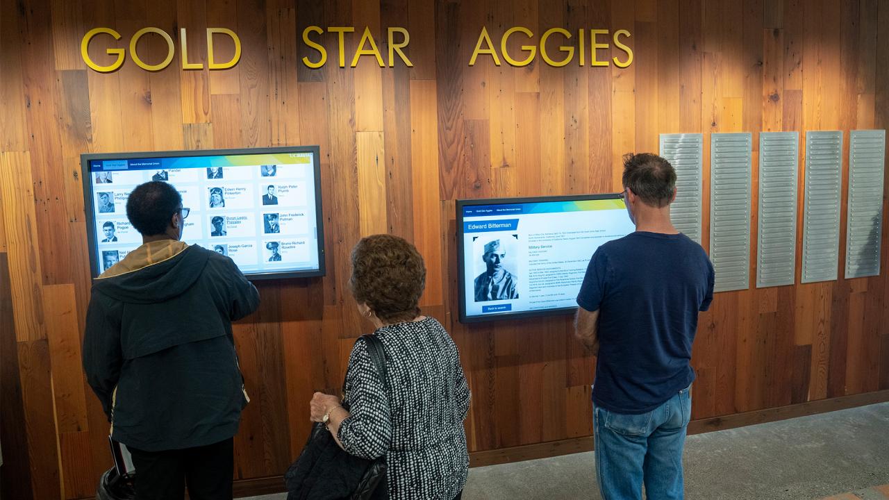 People look at Gold Star Aggies Wall in Memorial Union