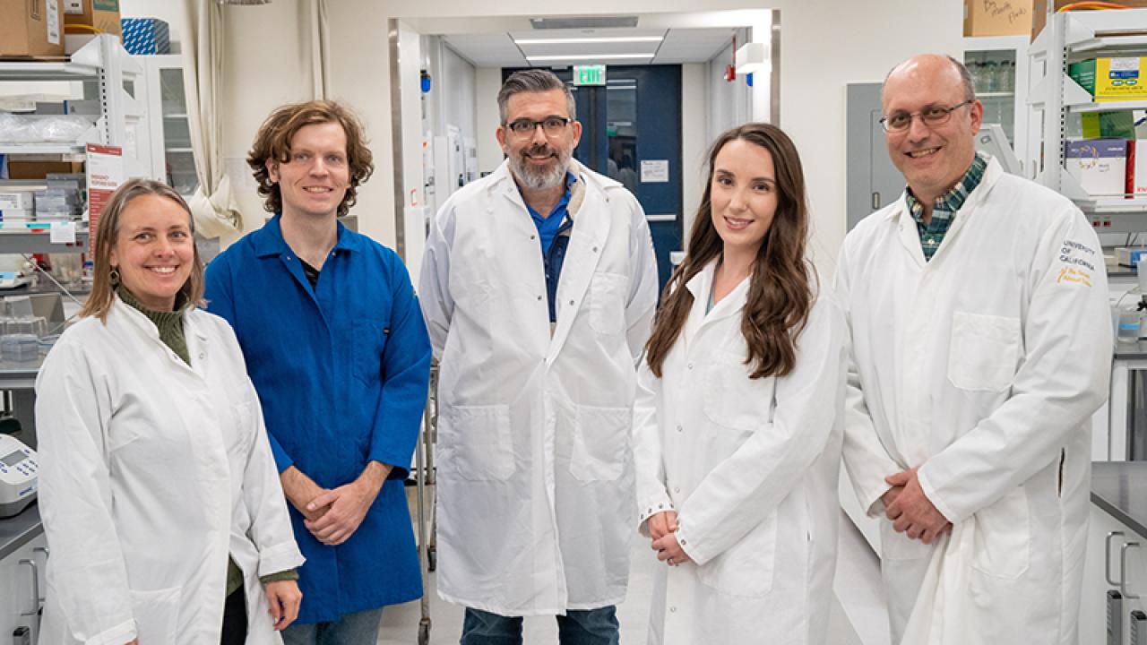 Group photo of five people in lab.