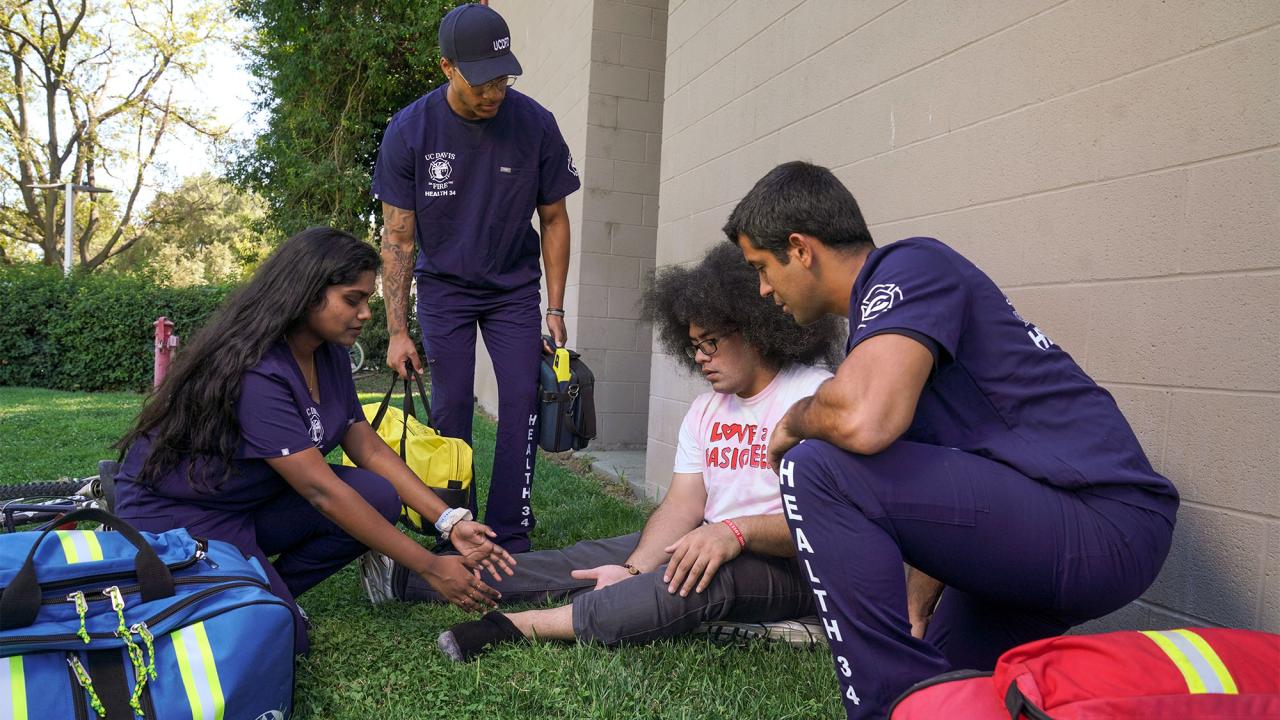 Student EMTs treat another student.