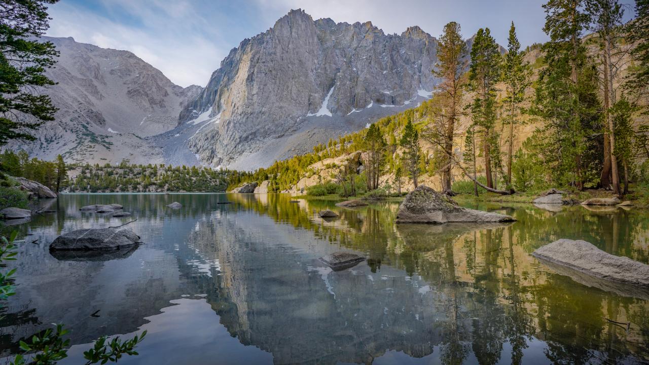 Alpine lake with backdrop of mountains in high elevations of Sequoia and Kings Canyon National Parks. 