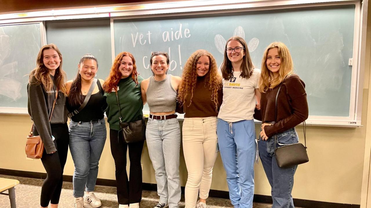 Orli Algrannati, President of the Vet Aide Club, stands smiling with other members of her club.
