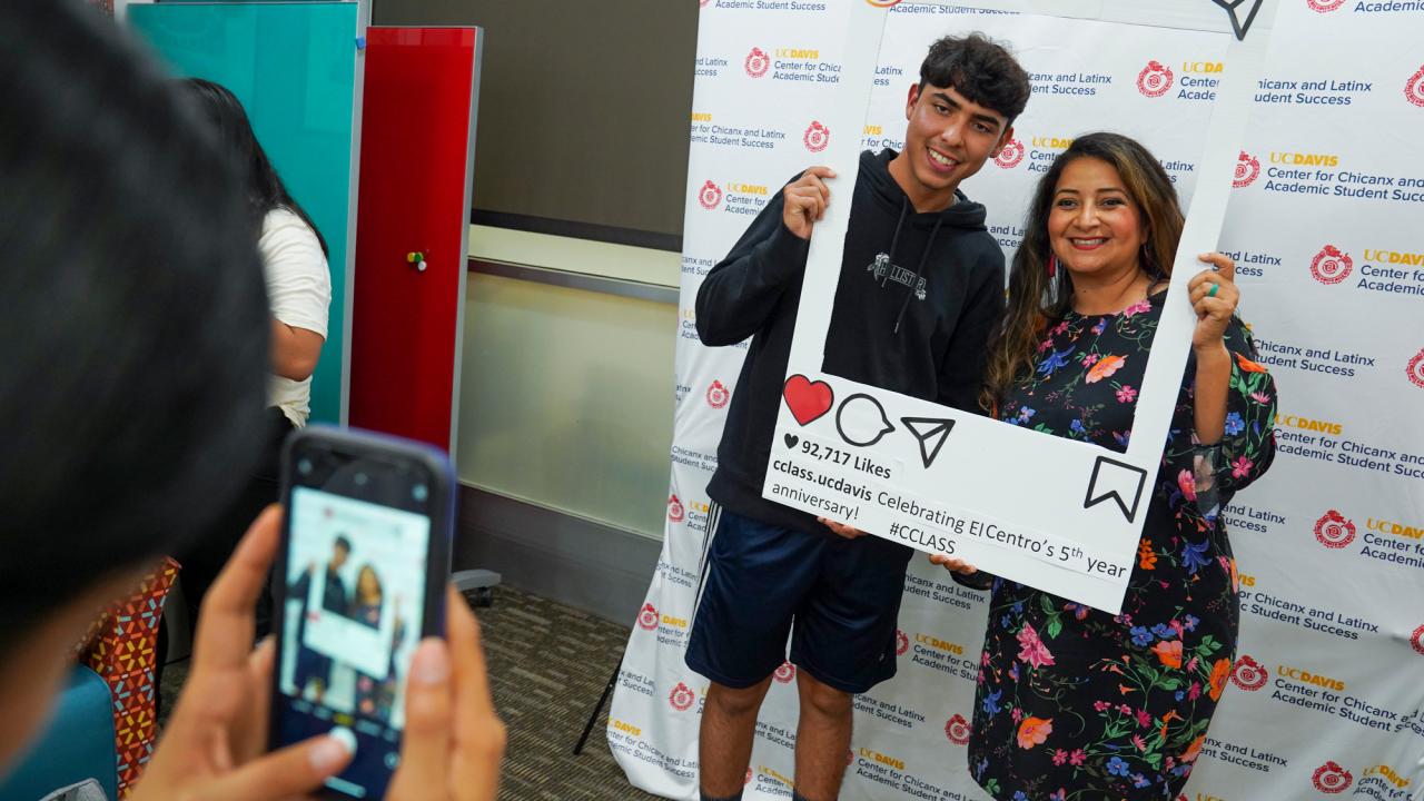 Student Julian Gomez and HSI Director Lina Mendez pose in Instagram photo frame