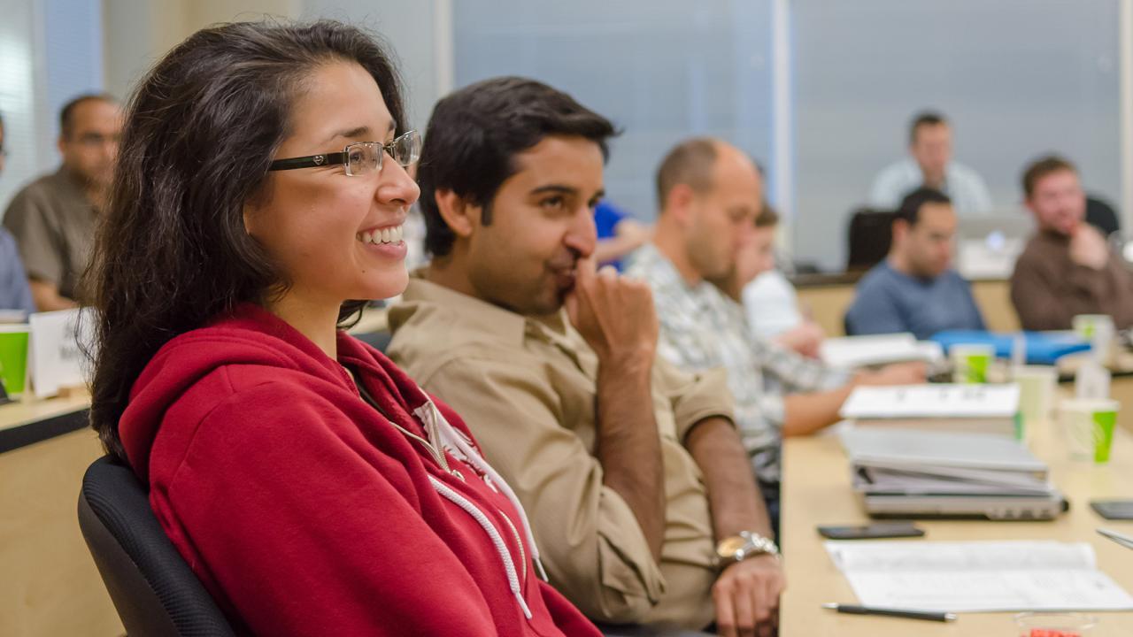 Students are seen from the side as they pay attention in class