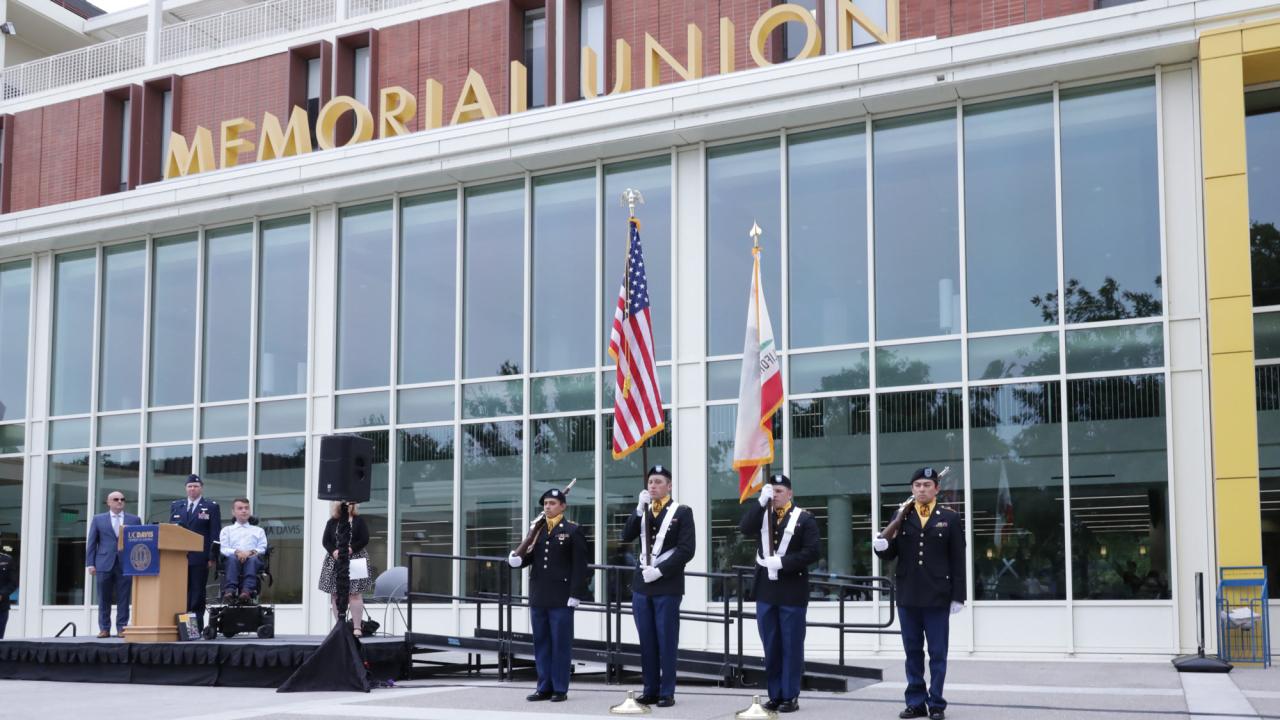 Army ROTC color guard under "Memorial Union" sign