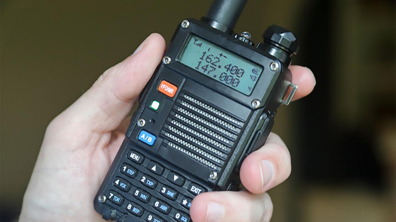 An amateur radio handset in a hand