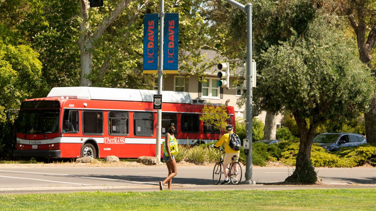 Russell Boulevard scene with Unitrans bus, pedestrian and bicyclist