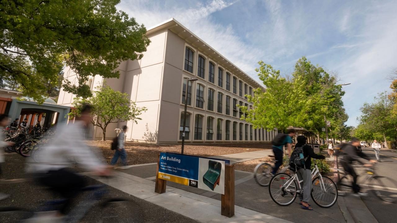 Arts Building at UC Davis with bicyclists riding by