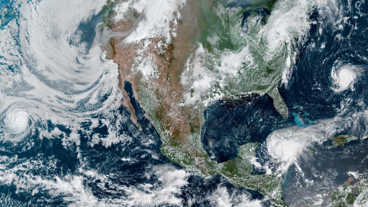 Map of North America showing multiple hurricanes and smoke events