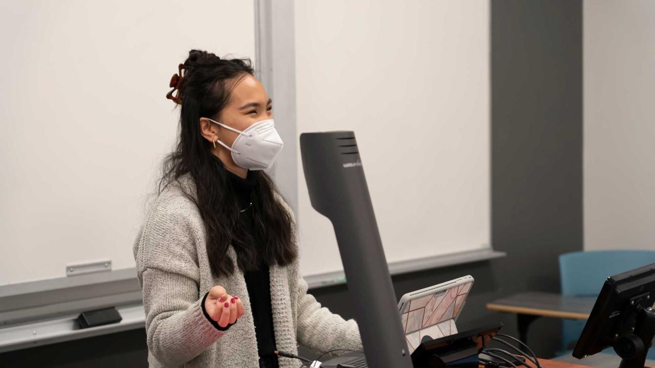 Lea Nglankong, a UC Davis undergraduate teaching assistant, stands in front of a chemistry support class and goes over a practice exam during winter quarter 2022.