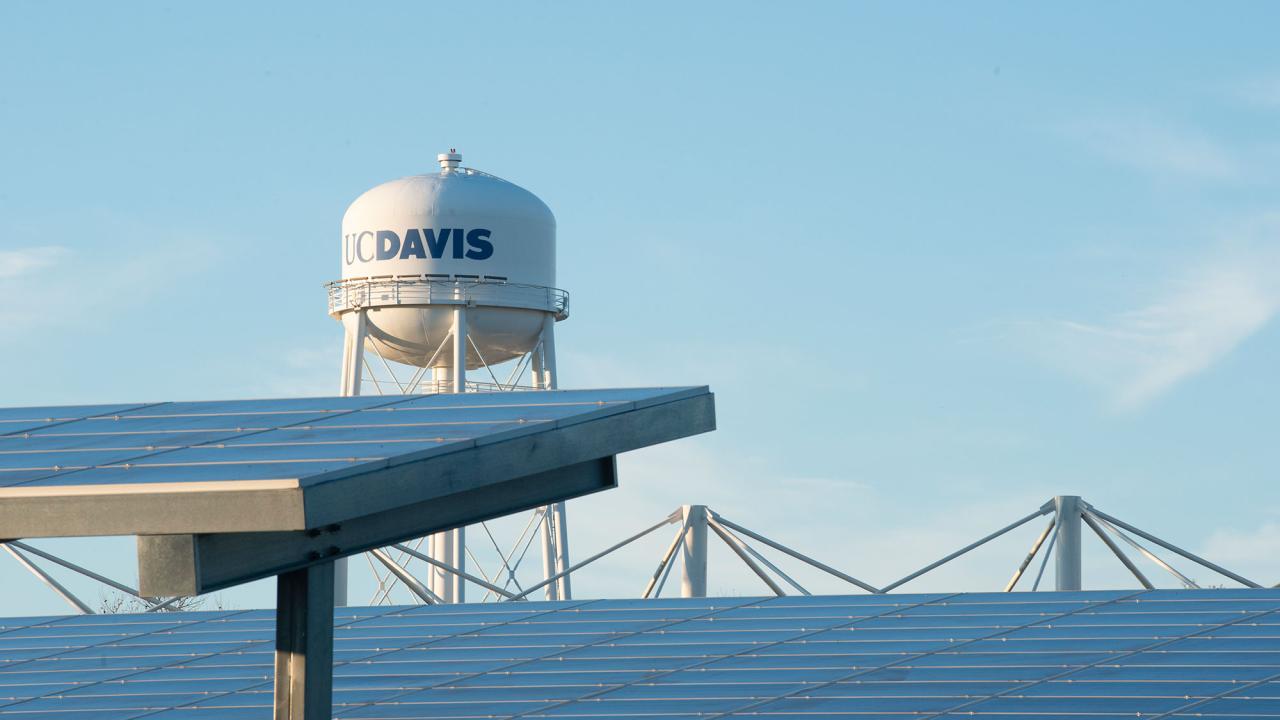 Tops of solar panels with UC Davis water tower in background