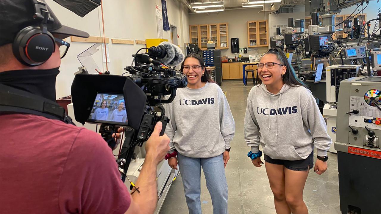 Twins laugh as they're being filmed for The College Tour