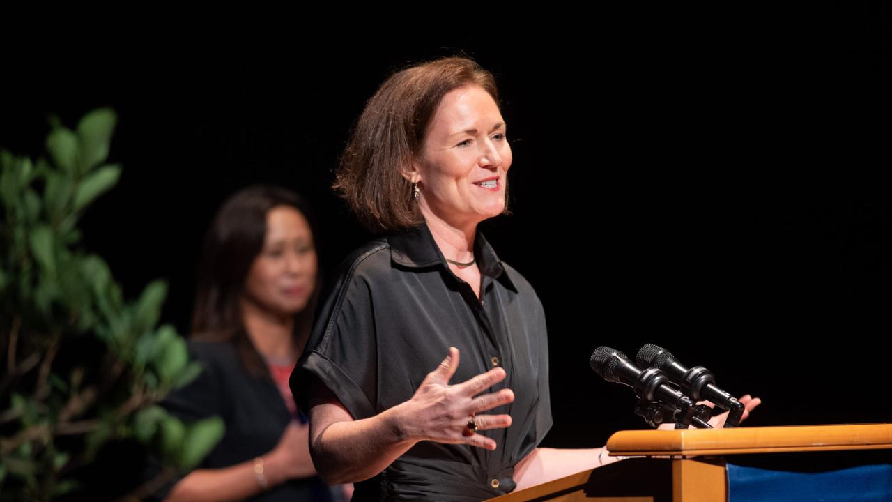 Leigh Ann Simmons, UC Davis faculty, speaking at podium