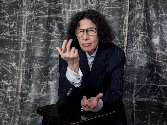 Fran Lebowitz in front of backdrop