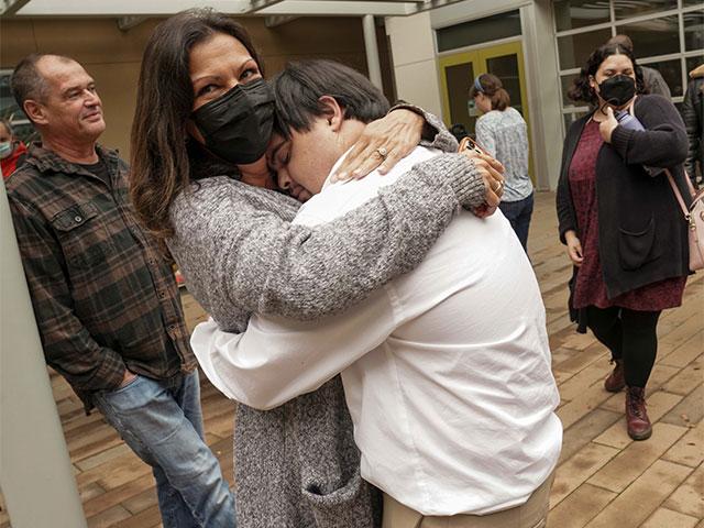 Ryan Fitch hugs his mom, Melissa, after the student exposition at the UC Davis International Center