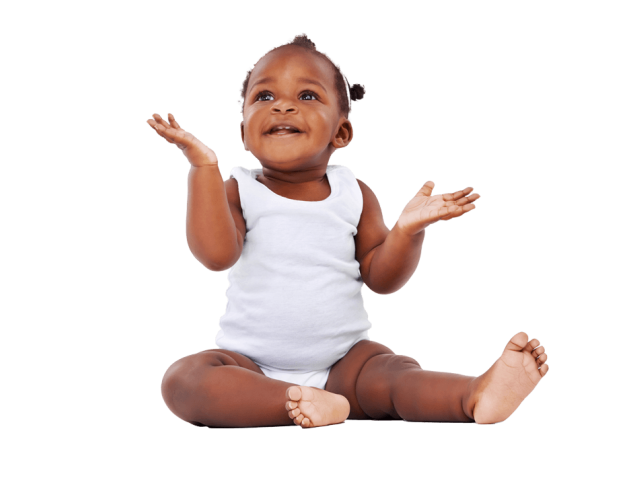 Smiling baby in white onesie sitting on white background, arms raised