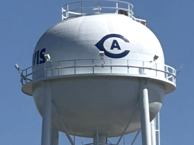 Closeup of newly restored water tower on campus shows Athletics logo