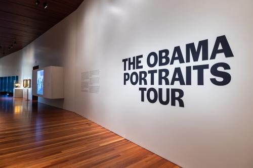 Photo of museum wall with title of exhibit for Obama Portraits